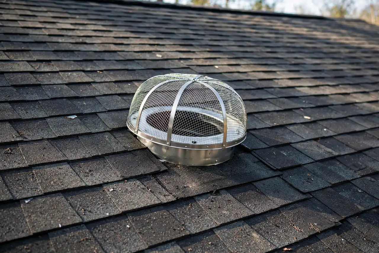 Metal mesh screen installed over a roof vent — Chimney Caps in Provo, UT